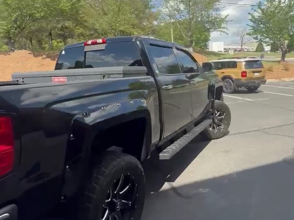 Black lifted pickup with tinted windows outside Black Optix Tint, serving Ballantyne, Charlotte NC