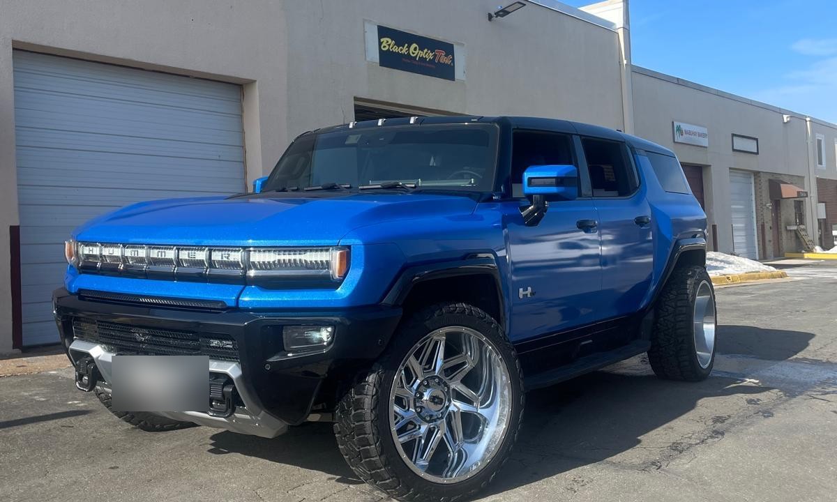 Blue GMC Hummer EV with ceramic window tint installed by Black Optix Tint, serving SouthPark, Charlotte NC